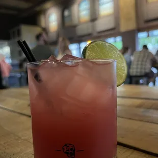 a pink drink with a lime slice