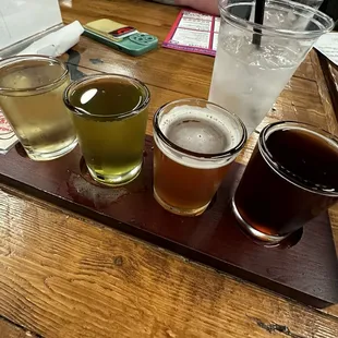 Beer flight. Light beer, sour, IPA and a brown ale.