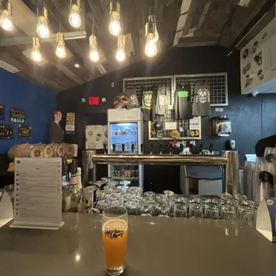 a glass of orange juice on the bar