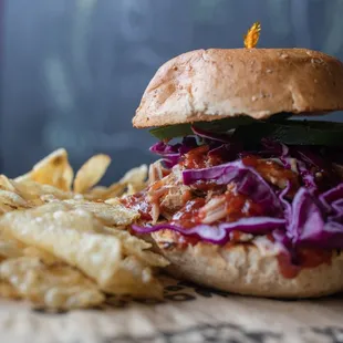 a pulled pork sandwich and chips