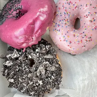 three different flavored donuts in a box