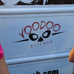a woman standing in front of a food truck