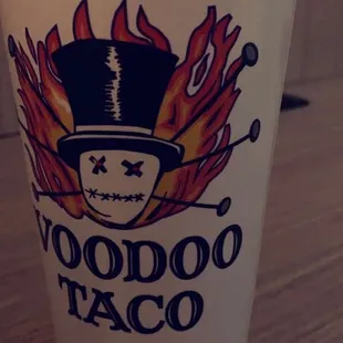 a cup with a skull and flames on it