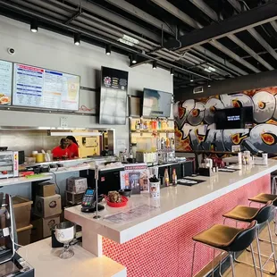 the counter and seating area of a restaurant