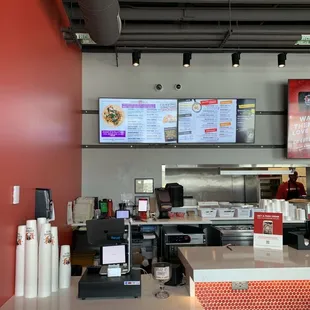 the counter and menus of a restaurant