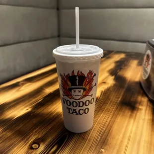 a plastic cup with a straw