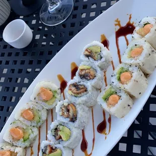 a plate of sushi and a glass of wine