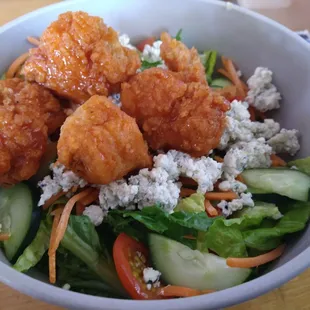 Lunch classic salad with blue cheese and boneless wings in medium buffalo sauce.