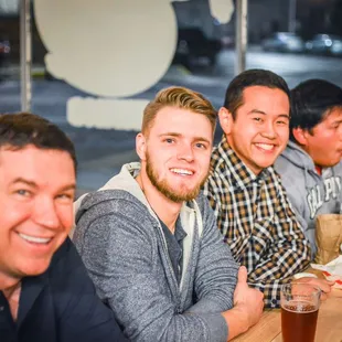 a group of men sitting at a table