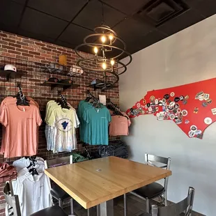 a table and chairs in front of a brick wall