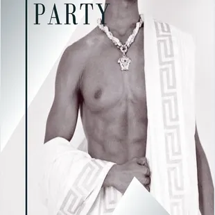 a shirtless man with a towel around his neck