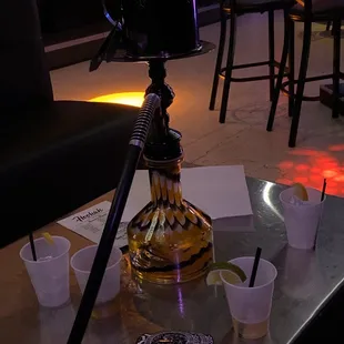 a hooket and cups on a table