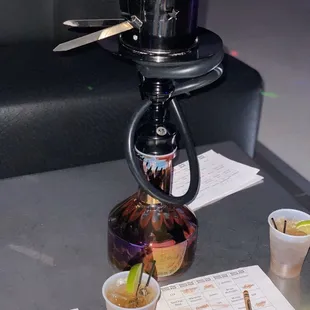 a coffee pot and cups on a table