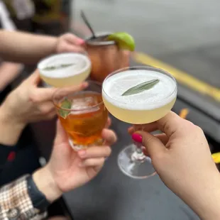 a group of people toasting with drinks