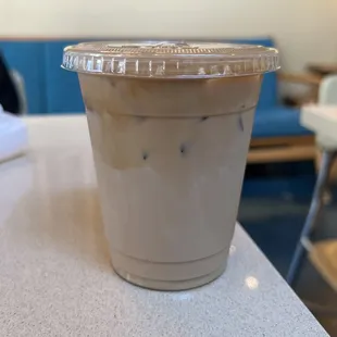 a cup of iced coffee on a table