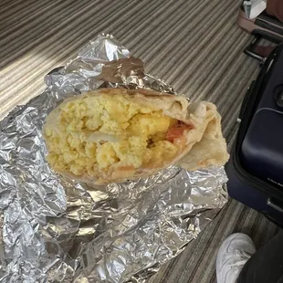 a breakfast burrito wrapped in aluminum foil