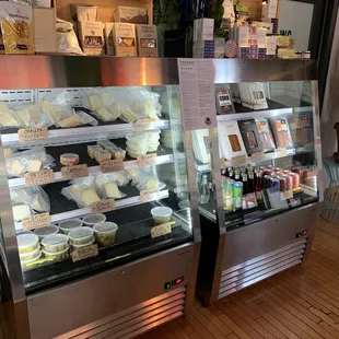 a display case of cheeses and pastries