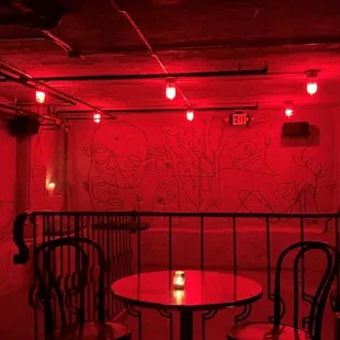 a table and chairs in a dimly lit room