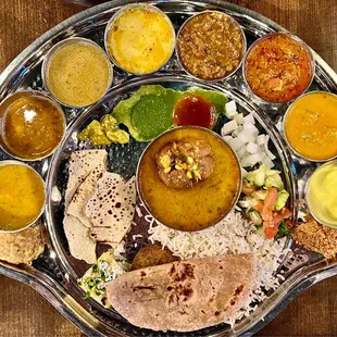 The Rajasthani Thali with Dal Bati.  Shiro  Tadka dal Dhaba dal Jaisalmer channa Kadhi Bangan bharta Paneer Gatta ki sabzi Ras malai  Churma