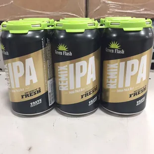 three cans of beer on a table