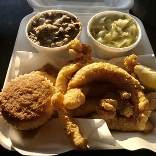 A fish dinner w/ black-eye-peas, cabbage, and cornbread.