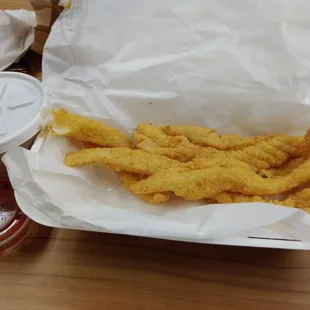 a basket of deep fried fish sticks