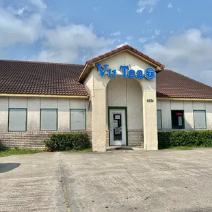 the front of a building with a car parked in front of it