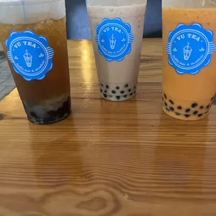 three different drinks on a table