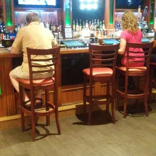 two people sitting at the bar