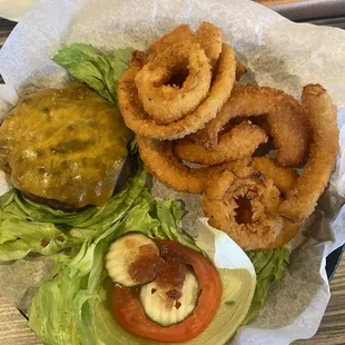 Burger wrapped in lettuce with onion rings