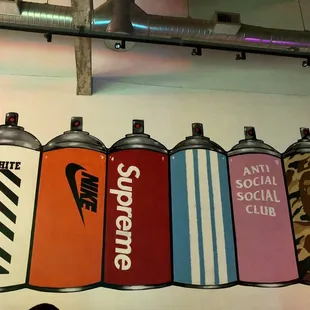 a row of spray cans on a wall