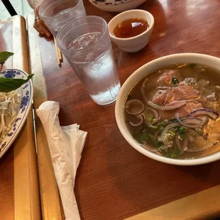 a bowl of soup and a plate of noodles