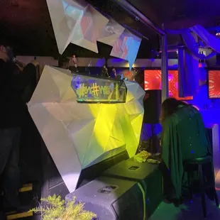 people sitting at tables in a dark room
