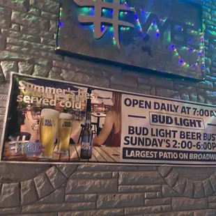 a brick wall with a sign for a bar