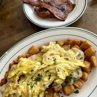 bistro potatoes, sausage gravy, and eggs with a side bacon
