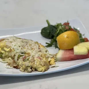 an omelet with a side of fruit