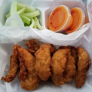 a basket of chicken nuggies and celery