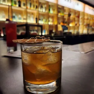 a glass of whiskey on a bar
