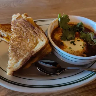 a bowl of soup and a grilled cheese sandwich