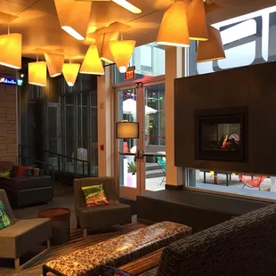 a lounge area with couches, tables, and lamps