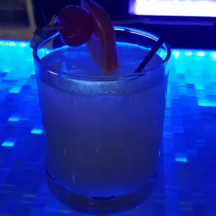 a drink with a garnish garnish