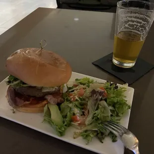 a burger and salad on a plate