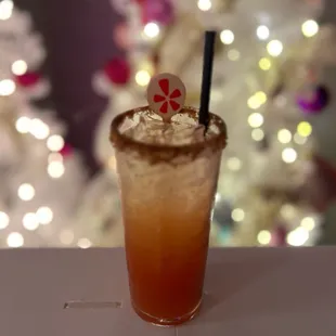 a drink in front of a christmas tree