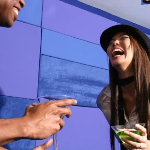 a woman laughing and holding a drink