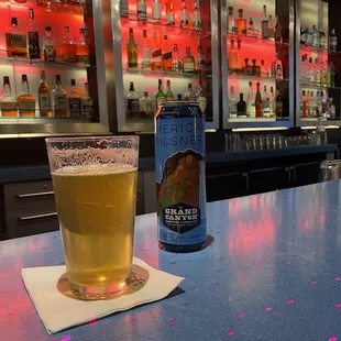 a glass of beer on a bar counter