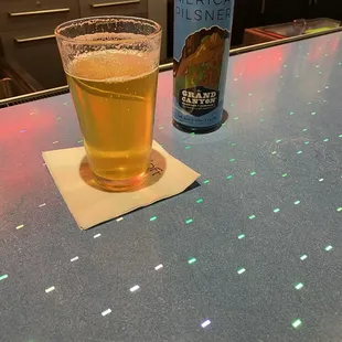 a glass of beer and a can of beer