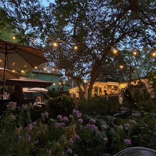 an outdoor dining area with tables and umbrellas