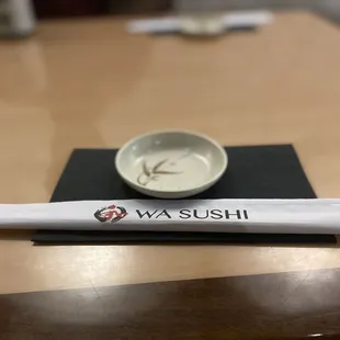 a small bowl and chopstick on a table