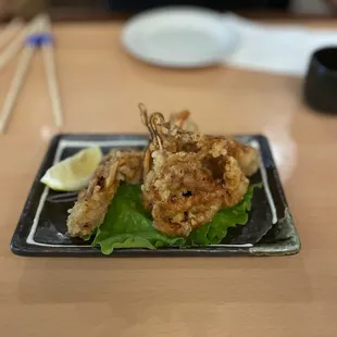 a plate of fried shrimp with lettuce