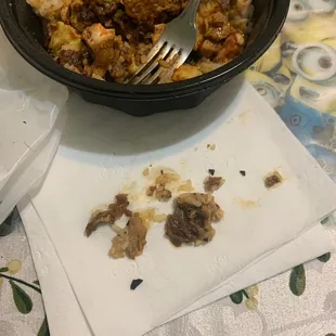 The little black pieces on the napkin are pieces of plastic...